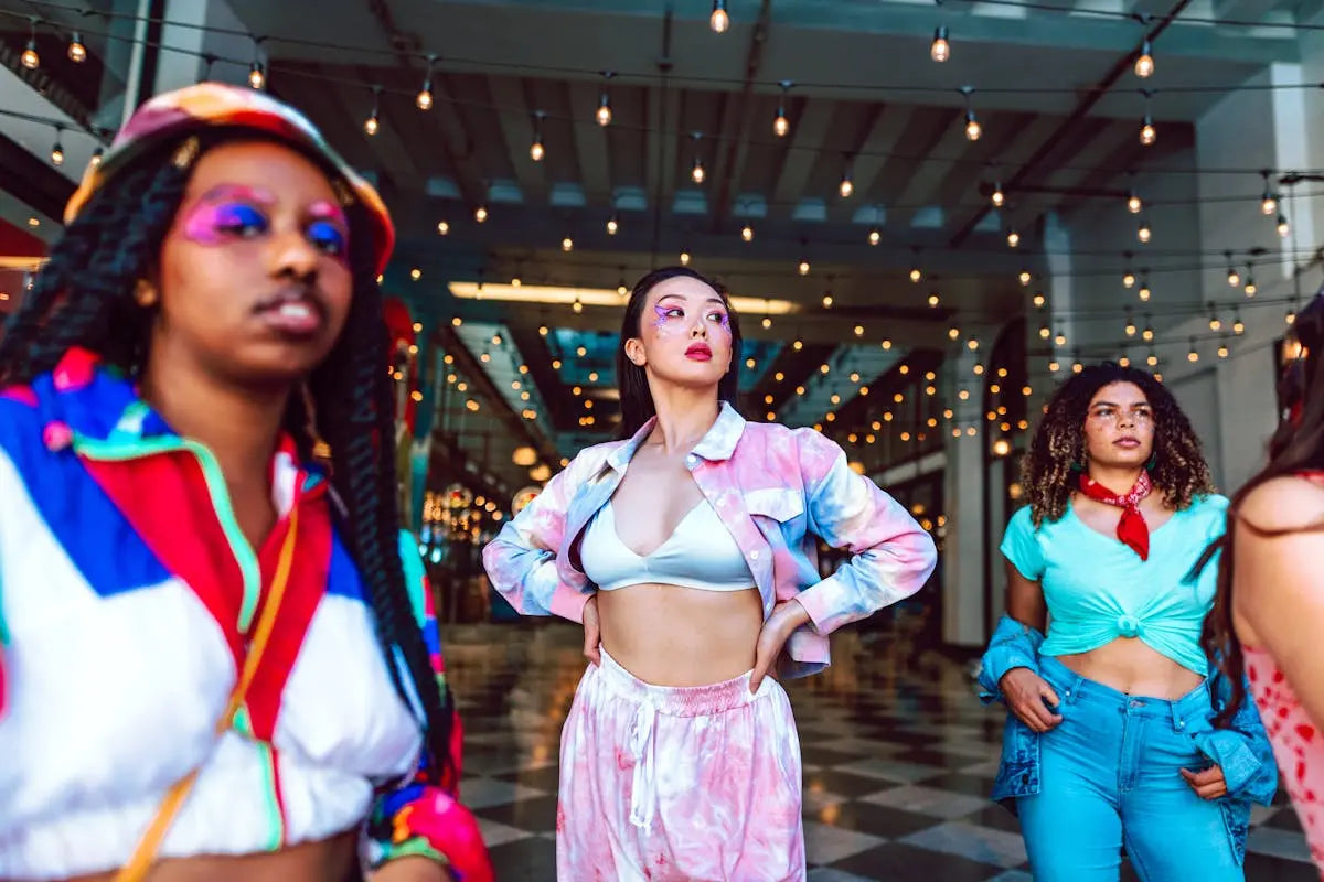 A sleek black leather handbag with gold hardware and a detachable shoulder strap, positioned against a plain backdrop.