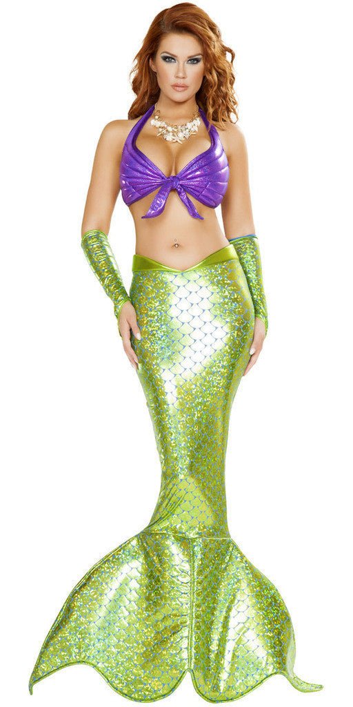 A woman in a mermaid-style gown poses confidently, showcasing the dress's elegant, form-fitting design in a fashion photo shoot.