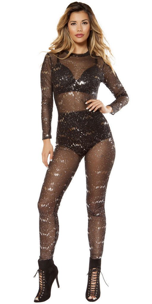 A woman wearing a black leotard and thigh-high boots, posing as a fashion model in a photo shoot.