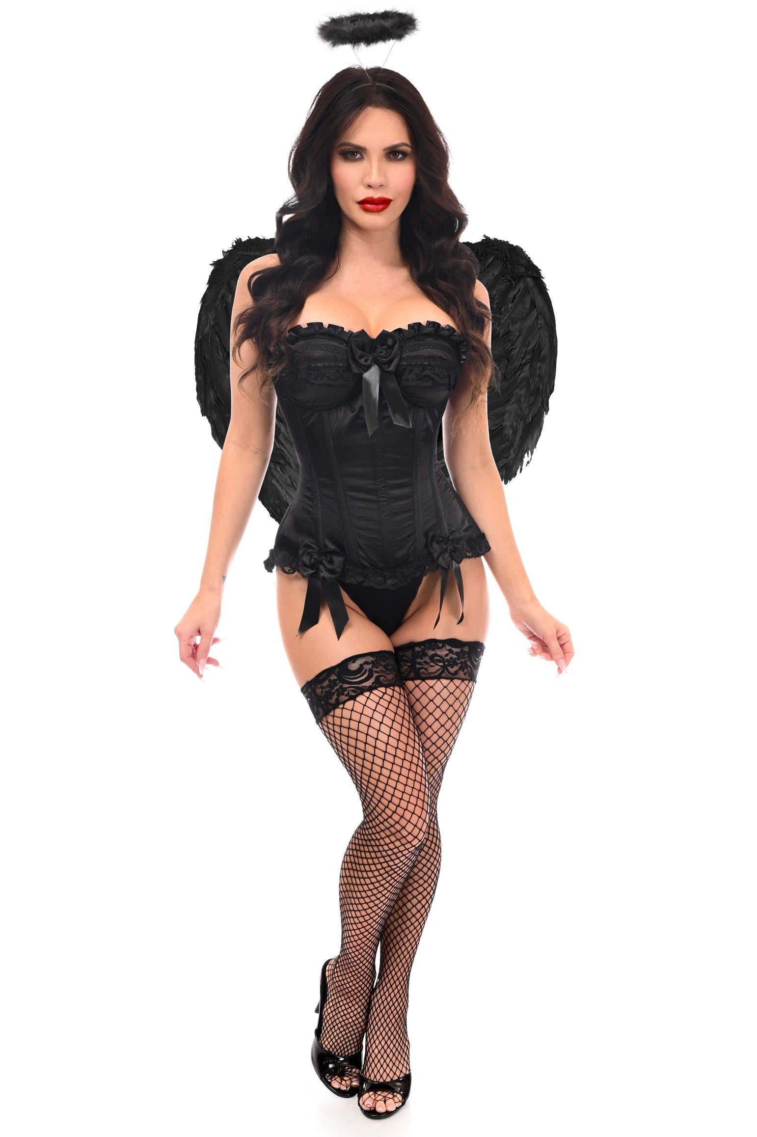 Woman wearing Exclusive 3 PC Burlesque Satin Corset Black Angel Costume with black halo, feathered wings, form-fitting corset, matching panties, thigh-high fishnet stockings, and high-heeled shoes. Hair long and wavy.