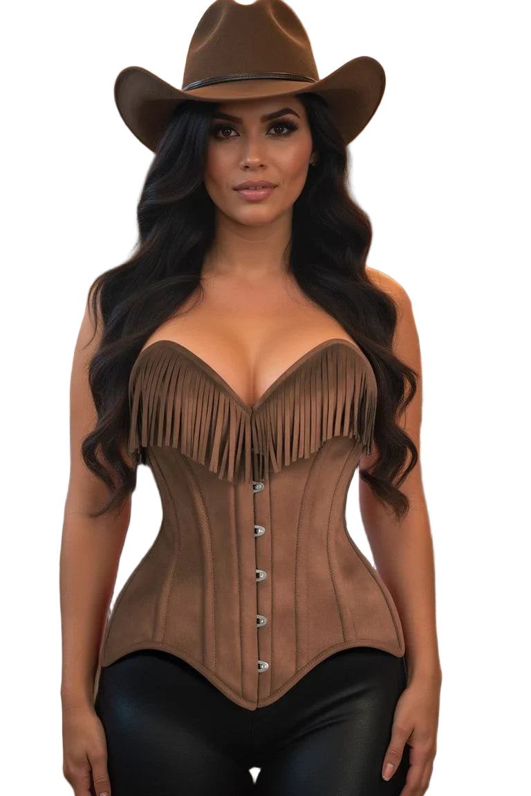 Woman wearing the Top Drawer Tan Suede Steel Boned Overbust Corset w/Fringe, featuring a deep V sweetheart neckline, front busk closure, and fringe details, in a cozy, western-themed setting.