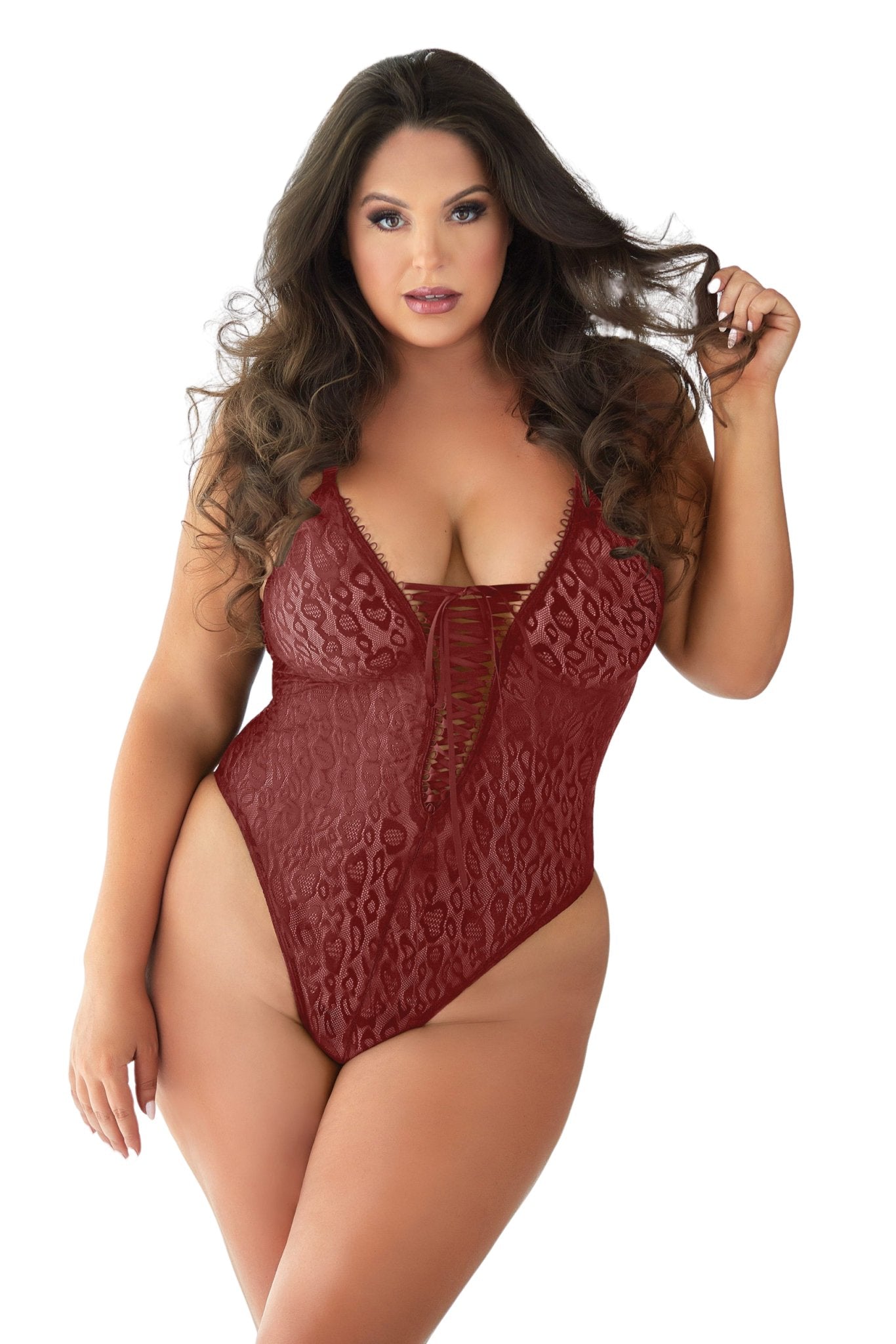 Woman wearing Curvy Burgundy Leopard Lace Teddy with lace-up front, criss-cross straps, and low-cut back, showcasing plus size fit in a fashion shoot.
