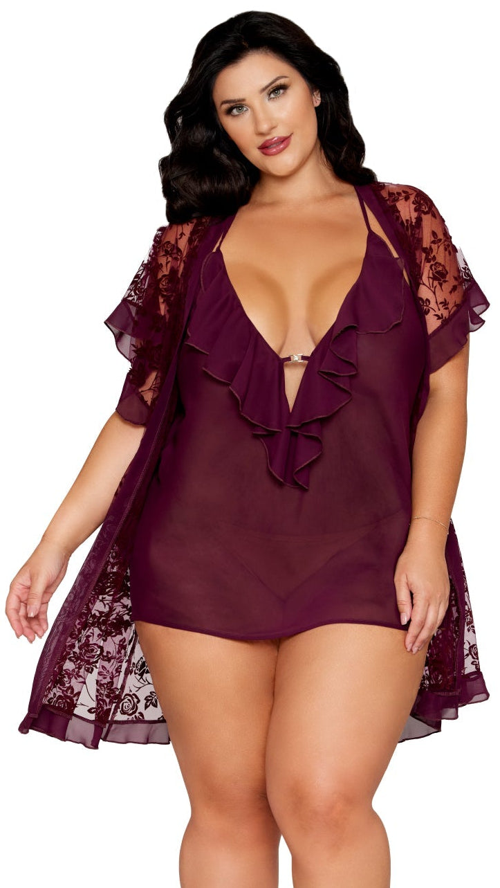A woman models the Plus Size Floral flocked mesh and chiffon robe and chemise set, showcasing flounce details and a plunging neckline with rhinestone accents.