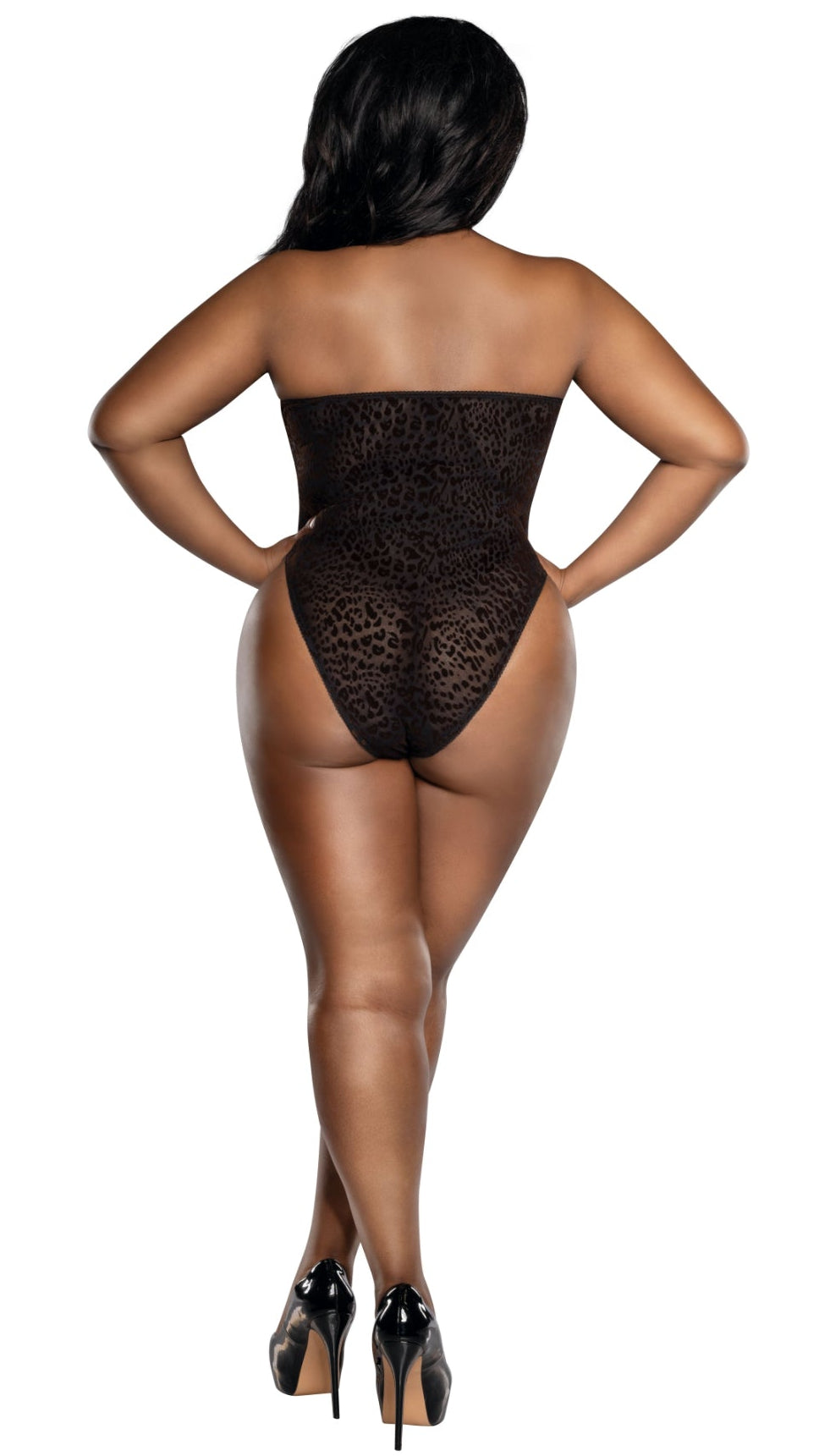 Rear view of a woman in a Plus Size Mocha leopard print flocked mesh halter neck teddy, strapless design, sheer black fabric, with crossed legs and glossy black stiletto heels, against a plain background.