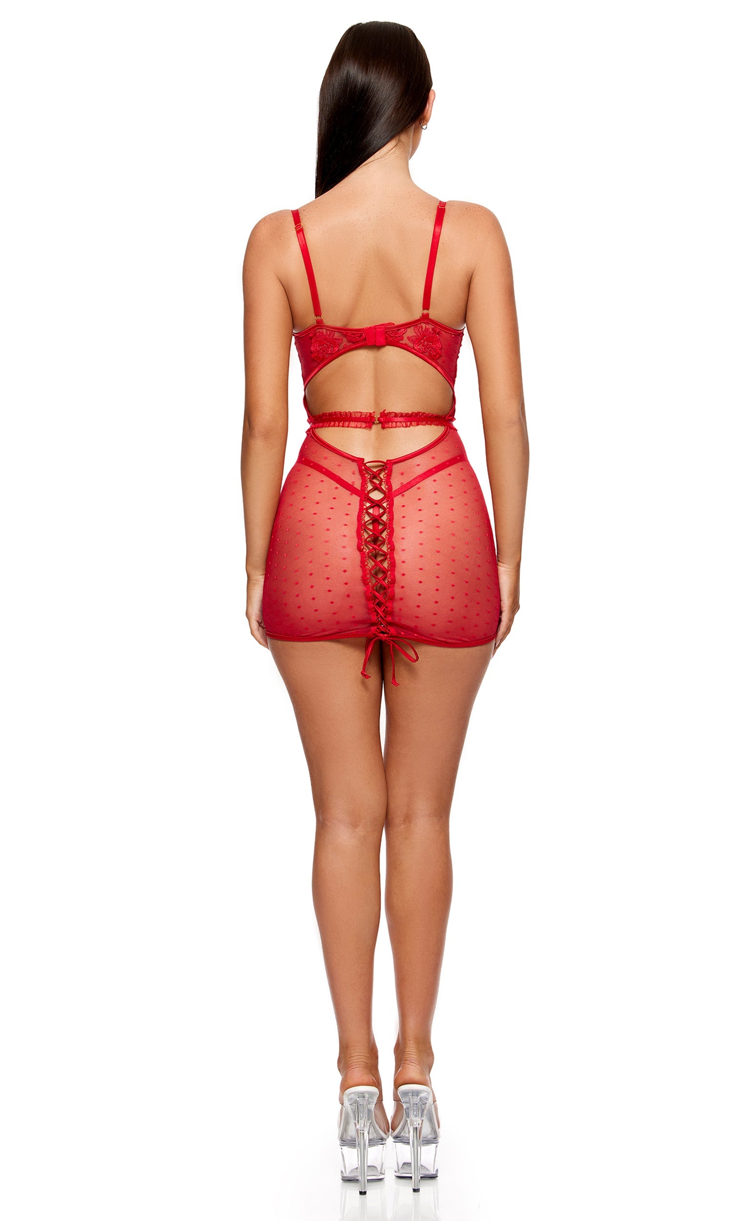Woman in La Vie en Rose Metallic Embroidered Chemise Set, featuring a sheer mini-dress with lace-up back detail, underwire cups, and a cut-out, paired with matching panty and belt.