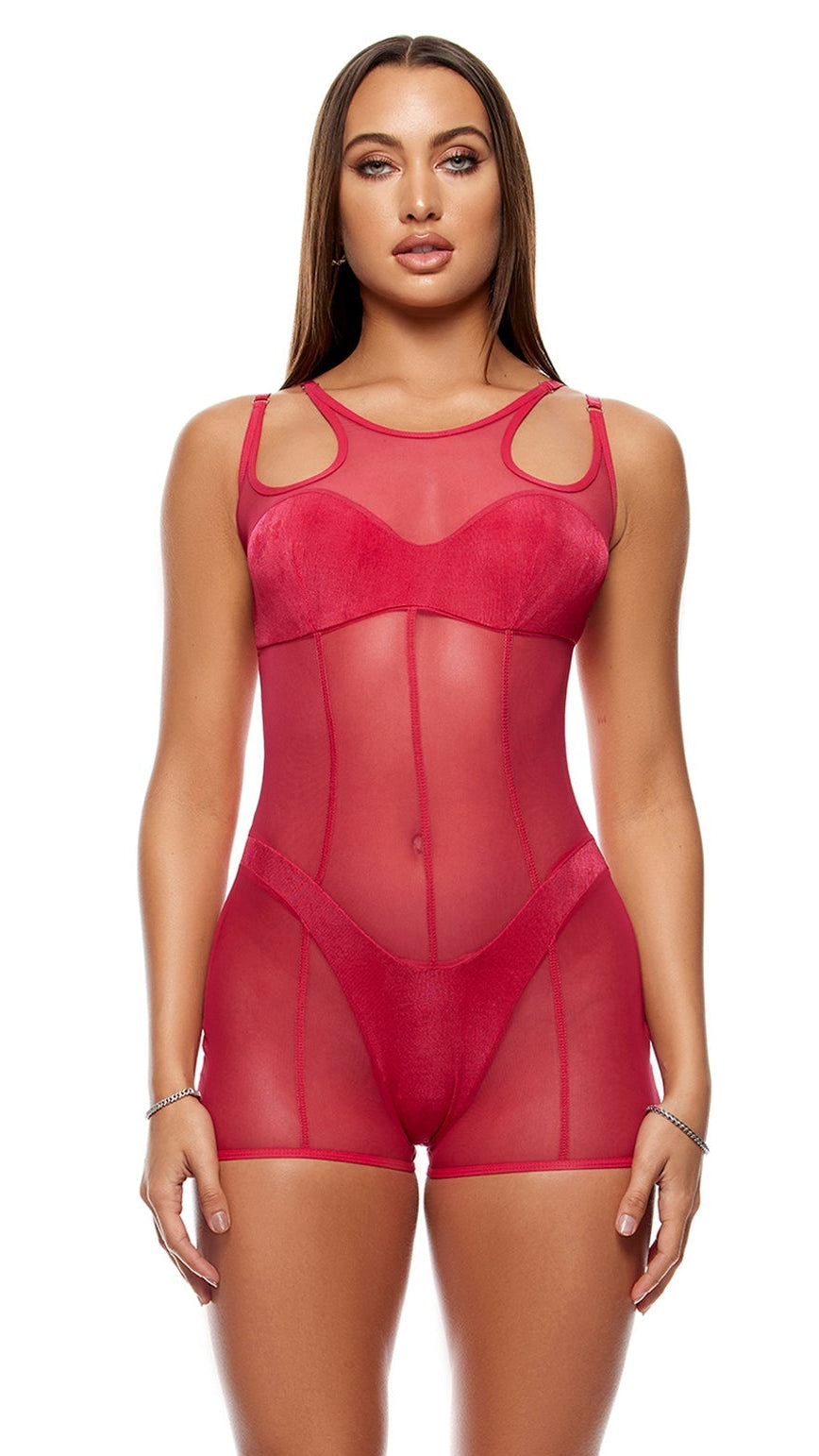 Model showcases the Layers To This Mesh and Knit Romper, featuring a semi-sheer design with shoulder cutouts and faux panty outline, paired with clear high-heeled sandals against a minimalist backdrop.