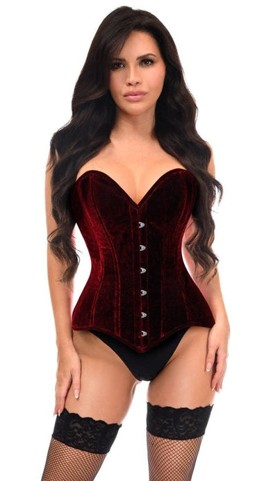 Woman models the Lavish Dark Red Velvet Overbust Corset Sweetheart Neckline Busk Closure, paired with black bikini bottoms and fishnet stockings, highlighting its structured support and flattering silhouette.