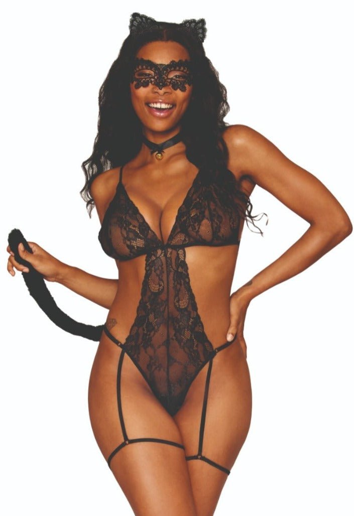 Woman modeling the Feline Fantasy Lace Garter Teddy 4-Piece Costume, featuring lace details, adjustable straps, leg garters, and a removable cat tail accessory.