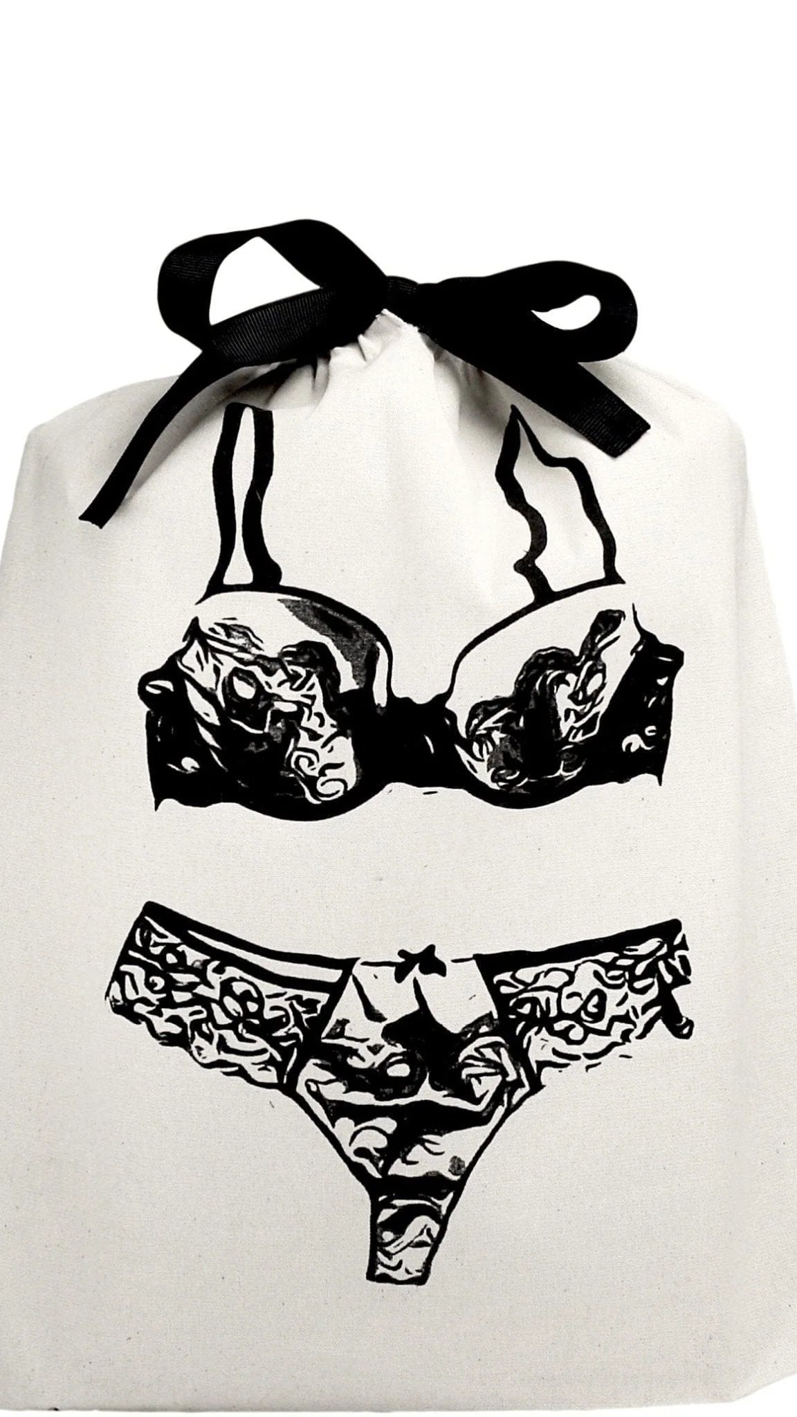 The Feeling Shy Bundle: A small, white draw-string bag featuring a black-ink illustration of a lacy bra and panties, symbolizing a curated selection of stylish, versatile intimate items and accessories.
