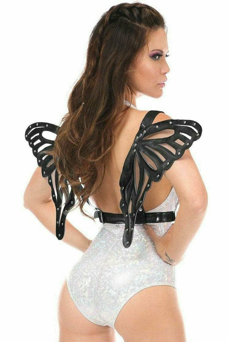 Woman models Black Patent Large Butterfly Wing Body Harness with sheer vinyl PVC wings and chrome hardware, highlighting its bold, adjustable design.