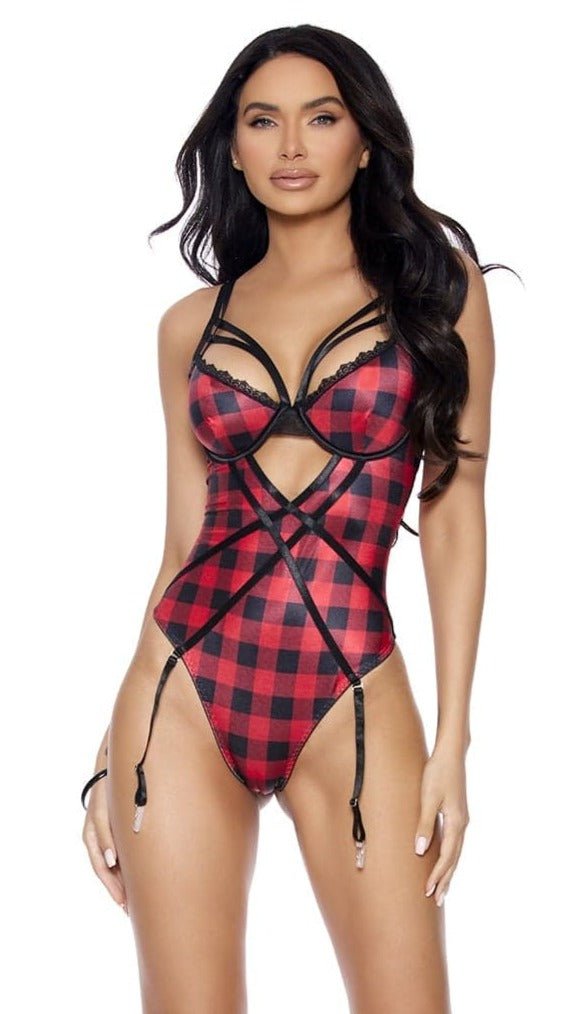 Holiday Buffalo Plaid Strappy Front Teddy worn by a model, highlighting its underwire cups, adjustable straps, and removable garters in a fashionable photo shoot setting.