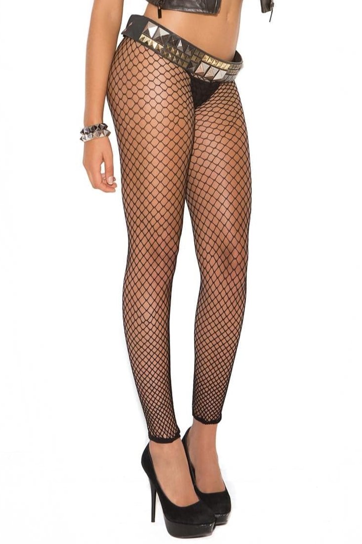 Woman wearing Plus Size Fence Net Leggings with fishnet design and leather vest, showcasing edgy style. High heels visible, emphasizing the leggings' fashionable appeal.