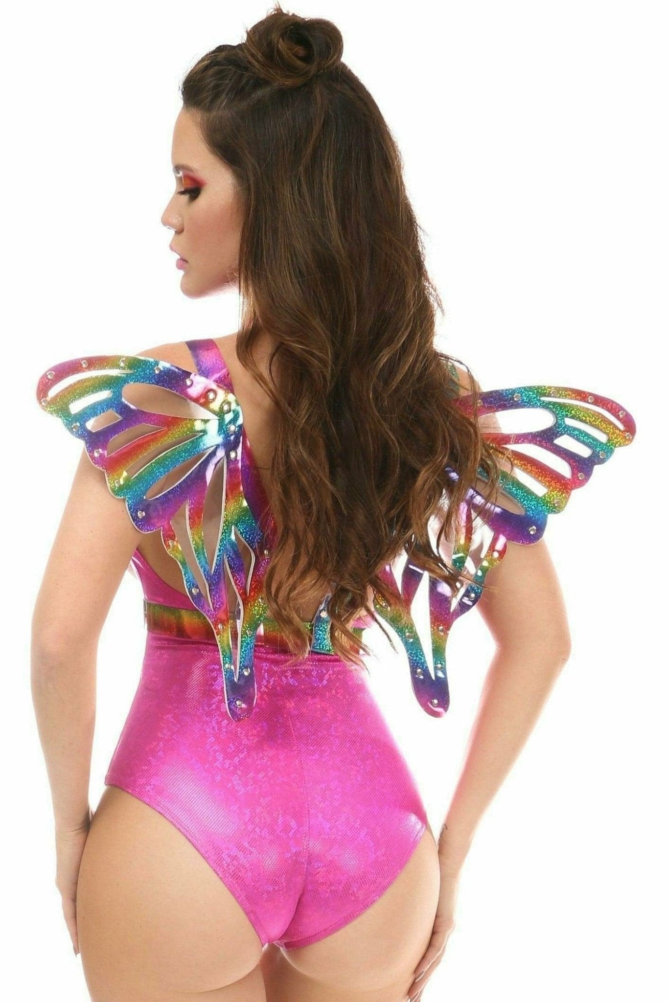 Woman in pink leotard models Rainbow Glitter PVC Large Butterfly Wing Body Harness with adjustable straps and chrome hardware during a fashion photo shoot.