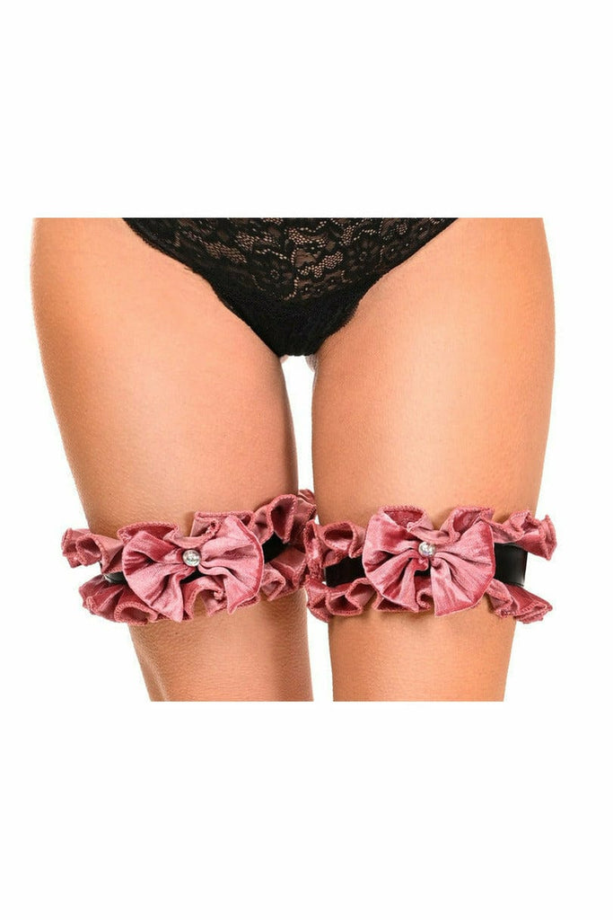 A woman wearing Sexy Dusty Rose Velvet Leg Garters with pink bows and rhinestone embellishment, showcasing their elegant bridal design and comfortable fit.