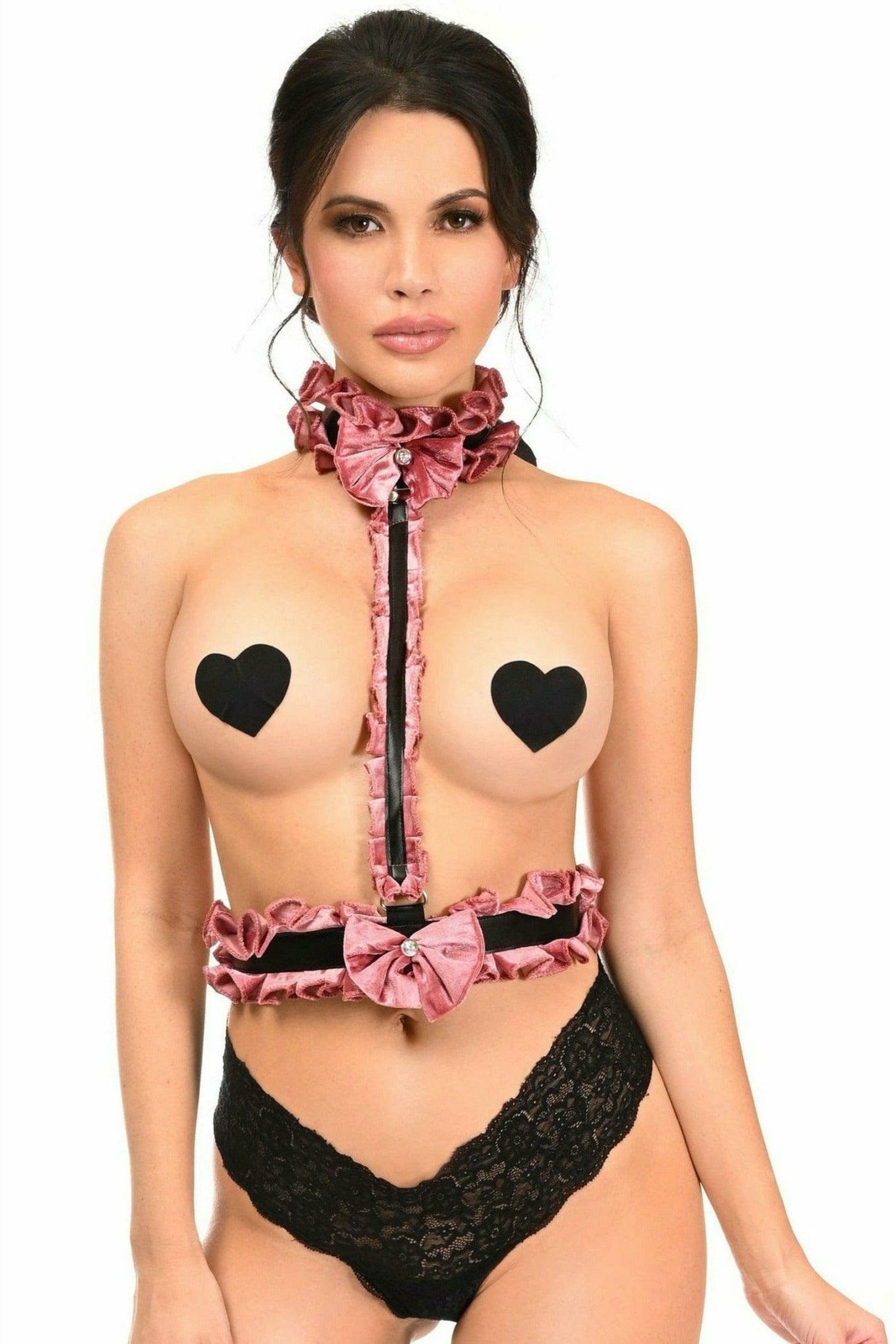 Woman modeling the Sexy Dusty Rose Velvet Single Strap Body Harness with a pink bow on a black belt, showcasing its unique design and rhinestone choker.
