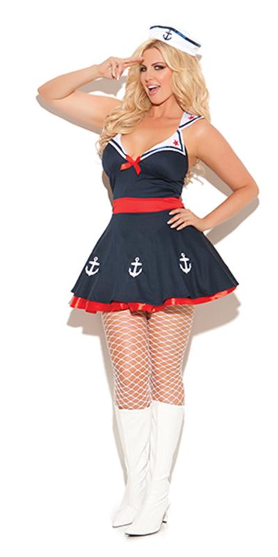 Woman wearing a Sexy Plus Size Ahoy Sailor Dress Costume with a white sailor hat, detailed with stars and anchors, paired with fishnet stockings.