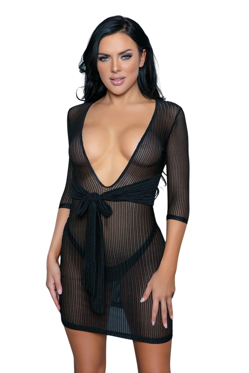 Woman modeling the Waist-Kissed Sheer Elegance Mini Dress with quarter sleeves, deep stretch neckline, and waist side tie, showcasing a chic and playful design.